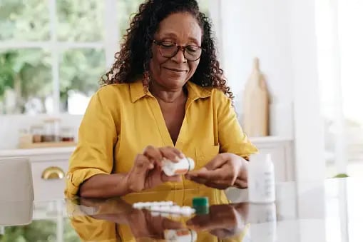 Woman_Black_60s-70s_TakingMedication_Home