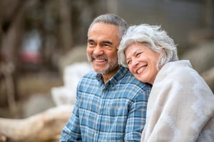 Man_Woman_Multiethnic_60s-70s_Cuddling_Outdoors